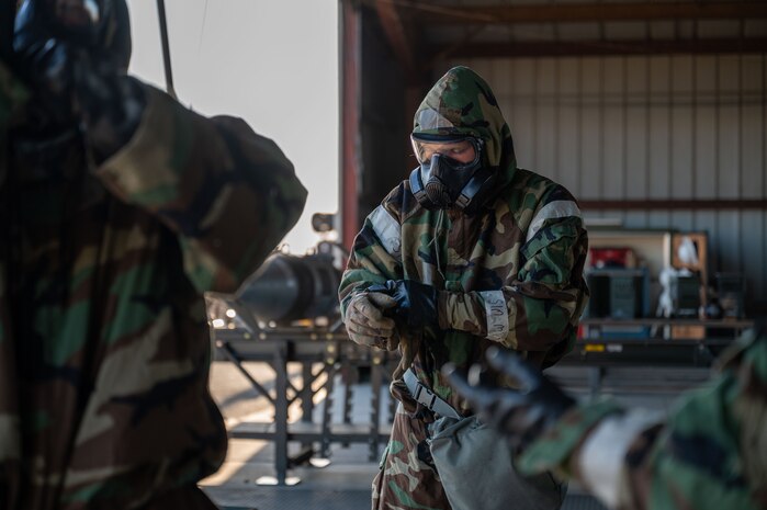 U.S. Air Force Airmen assigned to the 48th Munitions Squadron put on their Mission Oriented Protective Posture gear as part of Operation Exterminator at Beale Air Force Base, California, Aug. 15, 2025.