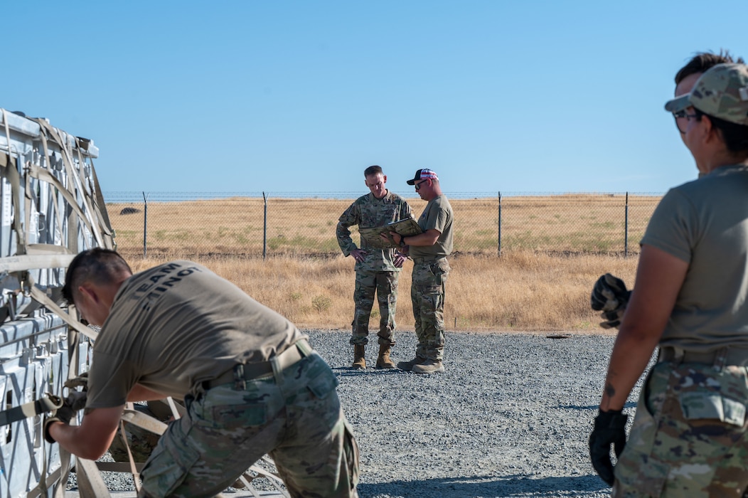 U.S. Air Force Brig. Gen. David S. Miller, Air Force Global Strike Command director of logistics and engineering, is briefed by Master Sgt. Adam Pawlak, 9th Munitions Squadron production section chief, on Operation Tomahawk as part of the Air Force Combat Operations Competition (AFCOCOMP) at Beale Air Force Base, California, Aug. 15, 2025.