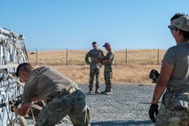 U.S. Air Force Brig. Gen. David S. Miller, Air Force Global Strike Command director of logistics and engineering, is briefed by Master Sgt. Adam Pawlak, 9th Munitions Squadron production section chief, on Operation Tomahawk as part of the Air Force Combat Operations Competition (AFCOCOMP) at Beale Air Force Base, California, Aug. 15, 2025.