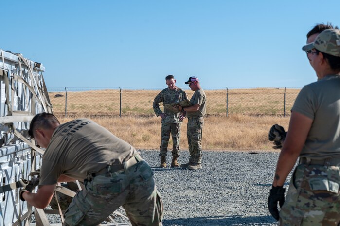 U.S. Air Force Brig. Gen. David S. Miller, Air Force Global Strike Command director of logistics and engineering, is briefed by Master Sgt. Adam Pawlak, 9th Munitions Squadron production section chief, on Operation Tomahawk as part of the Air Force Combat Operations Competition (AFCOCOMP) at Beale Air Force Base, California, Aug. 15, 2025.