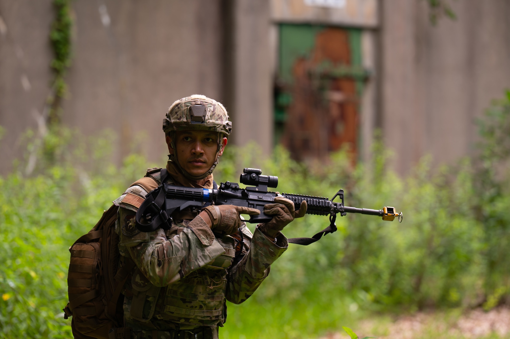 military man stands in forest