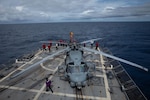 Sailors aboard the guided-missile destroyer USS Sampson conduct a foreign object and debris walkdown to prepare an MH-60R Sea Hawk helicopter, assigned to Helicopter Maritime Strike Squadron 49, for patrol while conducting maritime interdiction operations in the Eastern Pacific, Aug. 11, 2025.