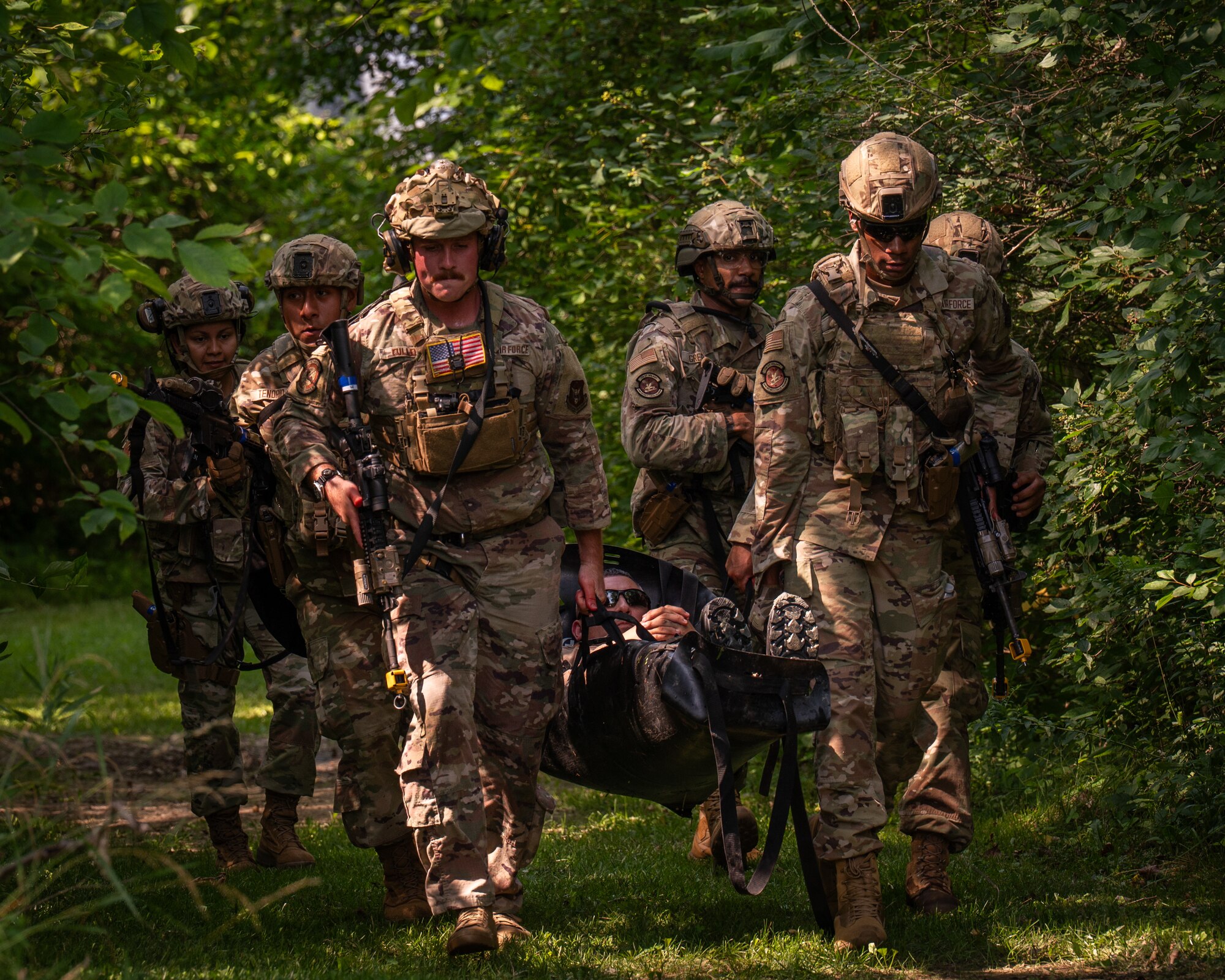 military members carry someone on a litter