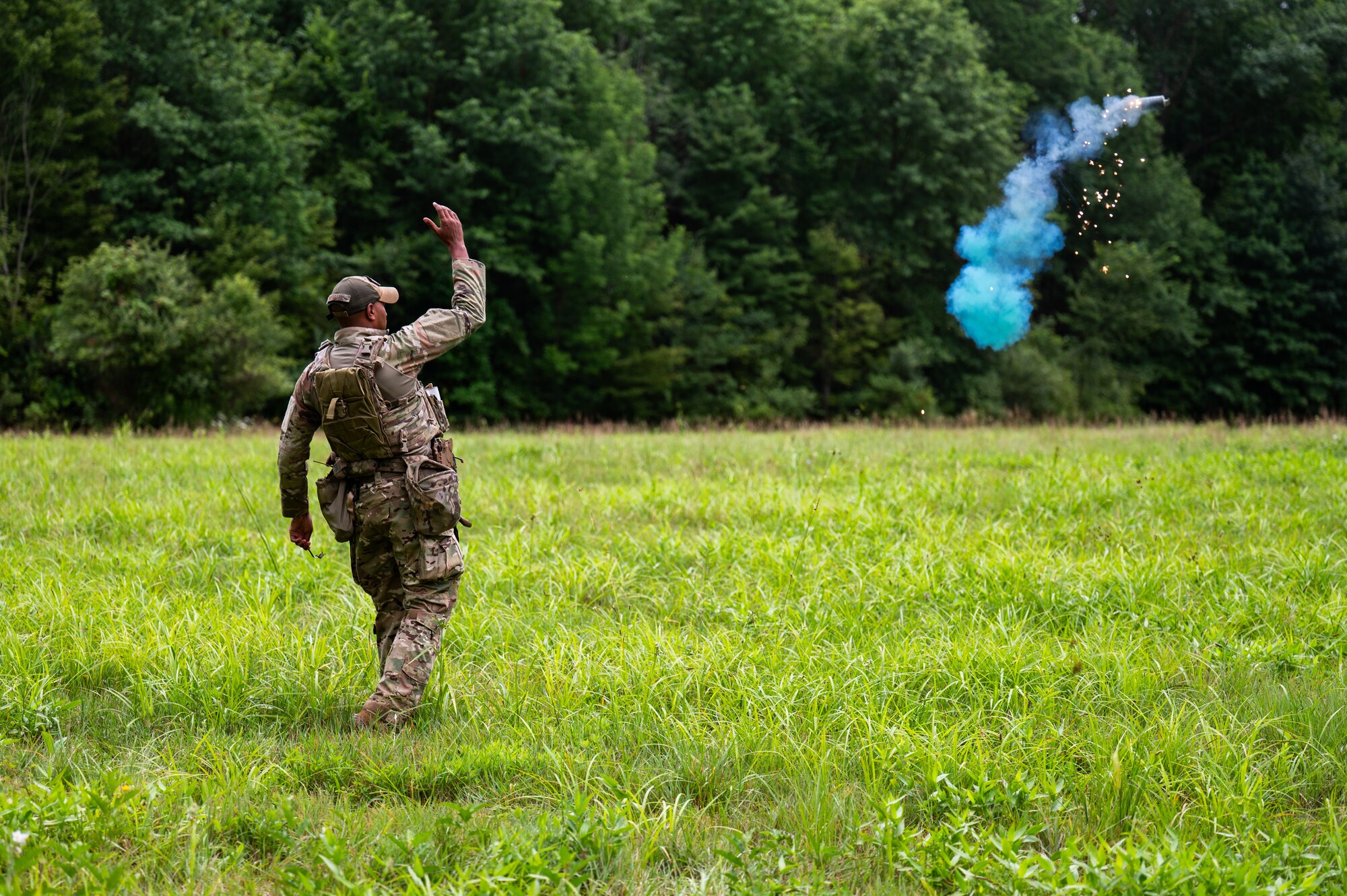 a man throws smoke grenade