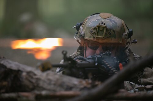 a military man with a machine gun