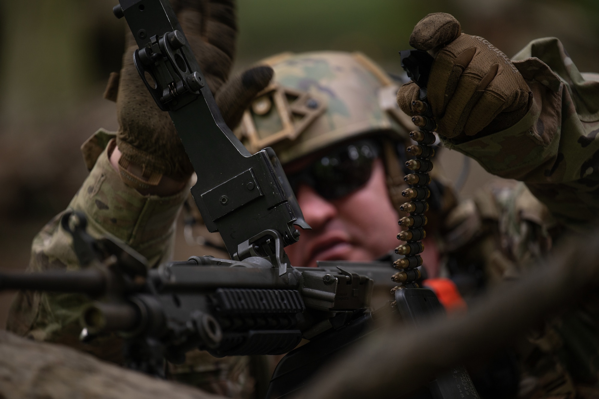 a military member with a machine gun