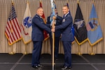 A colonel passes a flag to a lieutenant colonel