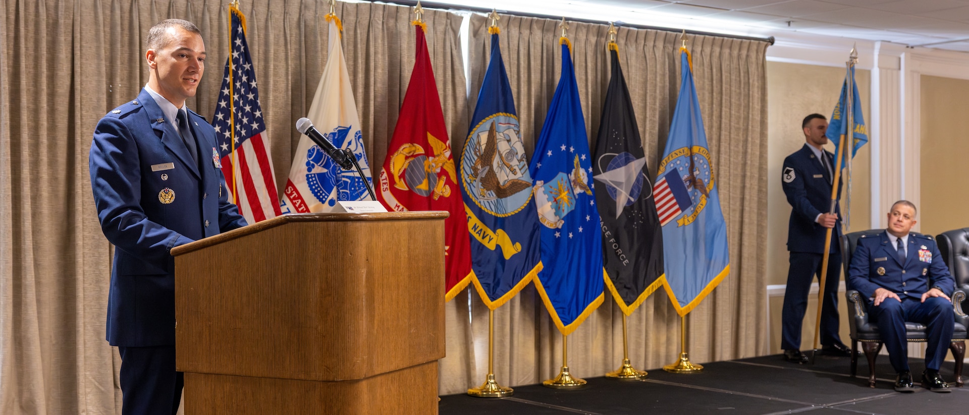 A lieutenant colonel speaks at a podium
