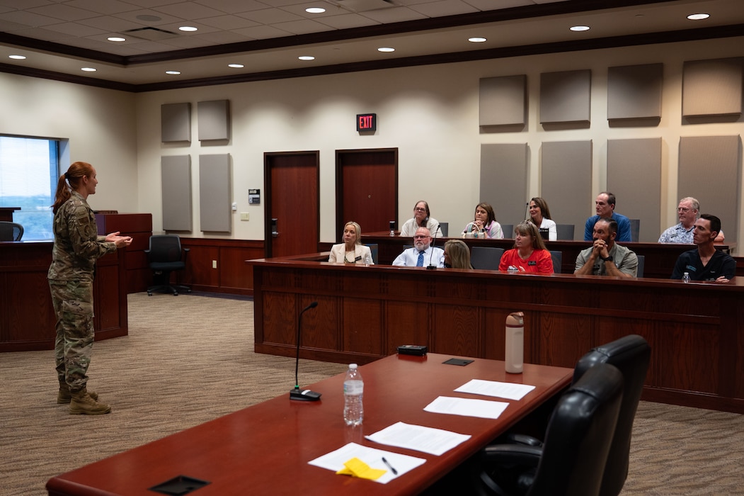U.S. Air Force Maj. Kelly Griffiths, 17th Comptroller Squadron commander, gives a Wing Staff Agencies overview brief to the honorary commanders at the court room inside the Norma Brown building, Goodfellow Air Force Base, Texas, Aug. 21, 2025. Griffiths explained the critical role that WSA plays in mission success by supporting Airmen from the background. (U.S. Air Force photo by Airman 1st Class Brian Lummus)