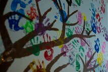 Previous residents of Chrisopher’s Haven leave hand prints on a mural inside an apartment at Christopher’s Haven, a temporary home for families and children receiving cancer treatment, during Marine Week Boston, Aug. 21, 2025. Marine Week Boston provides an opportunity for the Marine Corps to celebrate its 250th Birthday and connect with the community to show support while Christopher's Haven provides a supportive community of temporary apartments for families of children undergoing cancer treatment at nearby hospitals. (U.S. Marine Corps photo by Cpl. Vincent Needham)