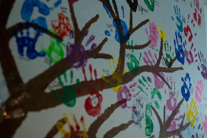 Previous residents of Chrisopher’s Haven leave hand prints on a mural inside an apartment at Christopher’s Haven, a temporary home for families and children receiving cancer treatment, during Marine Week Boston, Aug. 21, 2025. Marine Week Boston provides an opportunity for the Marine Corps to celebrate its 250th Birthday and connect with the community to show support while Christopher's Haven provides a supportive community of temporary apartments for families of children undergoing cancer treatment at nearby hospitals. (U.S. Marine Corps photo by Cpl. Vincent Needham)
