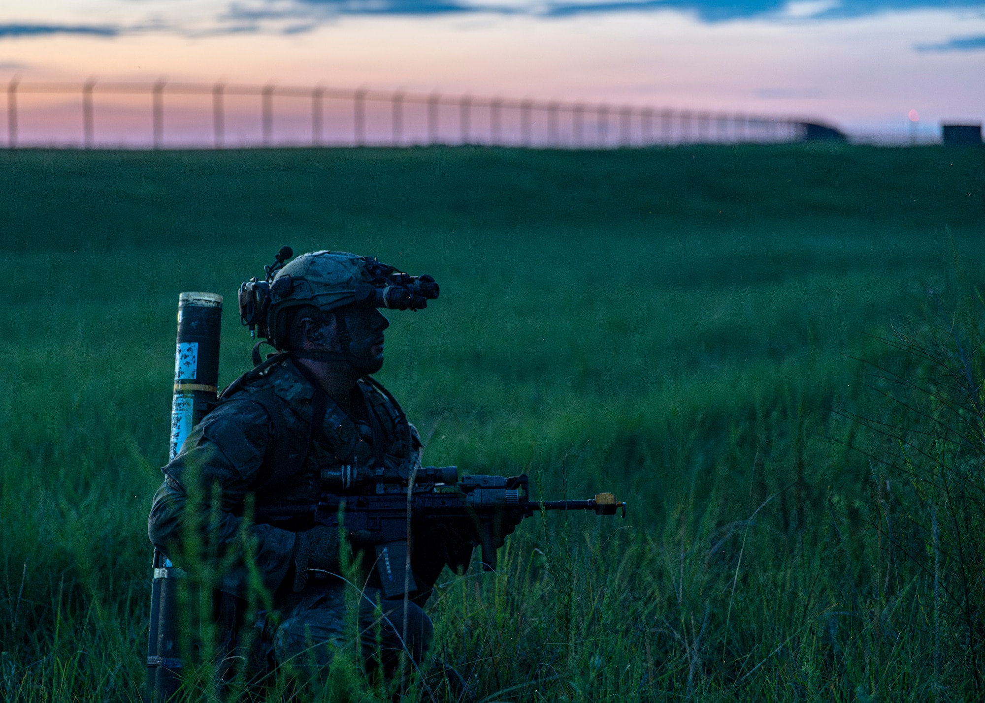 A U.S. Air Force Airman assigned to the 820th Base Defense Group kneels on watch at Moody Air Force Base, Georgia, Aug. 5, 2025. Airmen conducted perimeter security under low-light conditions to test their ability to perform mission-essential tasks during reduced visibility conditions. (U.S. Air Force photo by Senior Airman Leonid Soubbotine)