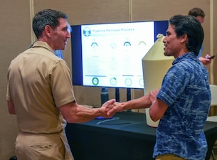 HONOLULU (Aug. 20, 2025) Capt. Robert Kleinman, facilities director, Navy Closure Task Force-Red Hill (NCTF-RH), speaks with a guest during the NCTF-RH open house at the Oahu Veterans Center in Honolulu, Aug. 20, 2025. The quarterly open house focused on tank cleaning operations, Tank Closure Plan Supplement 4, environmental remediation and monitoring, and reactivation of the Navy Aiea-Halawa Shaft. Charged with the safe decommissioning of the Red Hill Bulk Fuel Storage Facility (RHBFSF), NCTF-RH was established by the Department of the Navy as a commitment to the community and the environment. The Navy continues to engage with the people of Hawaii, regulatory agencies, and other stakeholders as NCTF-RH works to safely and deliberately decommission the RHBFSF. (U.S. Navy photo by Mass Communication Specialist 1st Class Glenn Slaughter)
