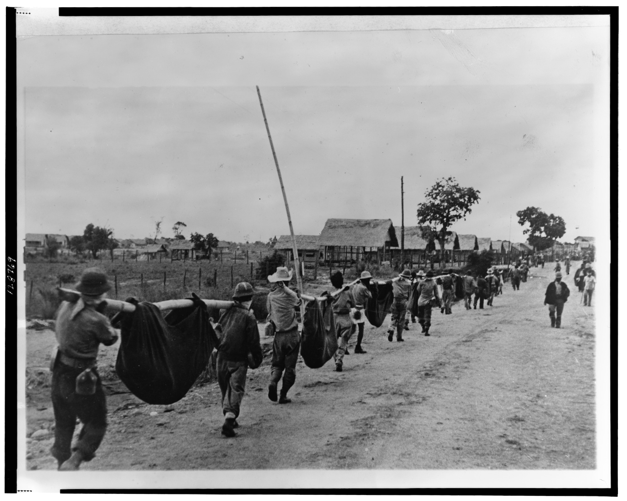 Burial details carry the remains of POWs who died of exhaustion, disease, or execution after reaching Camp O’Donnell.