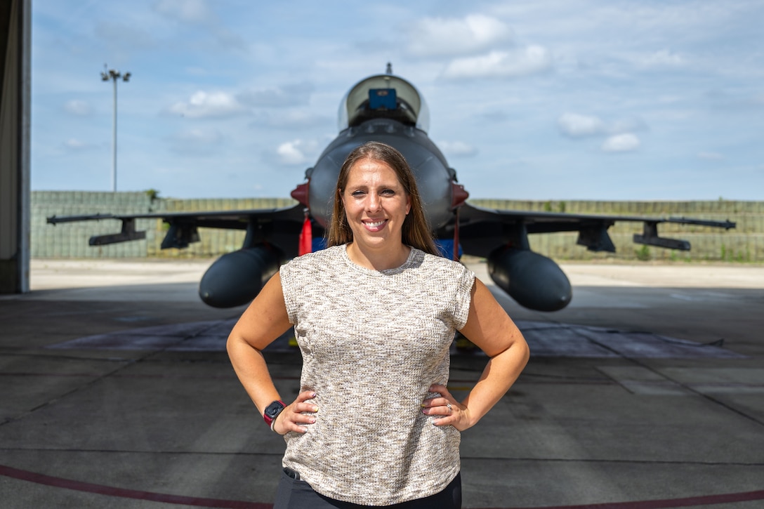 Person stand in front of plane.