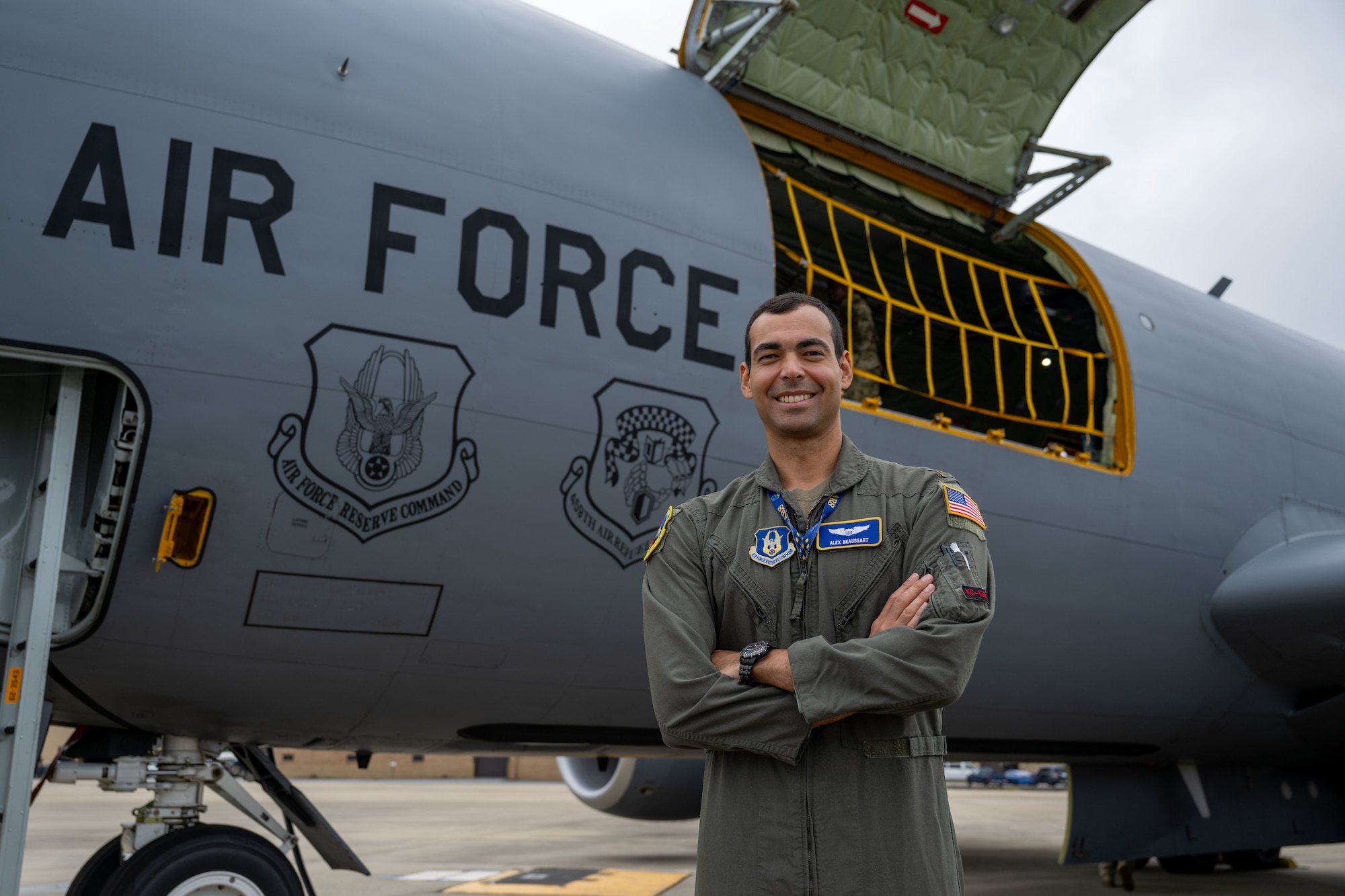 Pilot stands in front of plane.