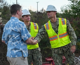 Tim Nelson, left, chief of staff for Rep. Ed Case, shakes hands with Rear Adm. Marc Williams, right, deputy commander of Navy Closure Task Force–Red Hill (NCTF-RH), during a site visit to the Red Hill Bulk Fuel Storage Facility (RHBFSF) in Honolulu on Aug. 7, 2025. Charged with the safe decommissioning of the facility, NCTF-RH was established by the Department of the Navy as a commitment to the community and the environment. NCTF-RH continues to engage with the people of Hawaii, regulatory agencies, and other stakeholders as it safely and deliberately decommissions the RHBFSF. (U.S. Navy photo by Mass Communication Specialist 1st Class Glenn Slaughter)