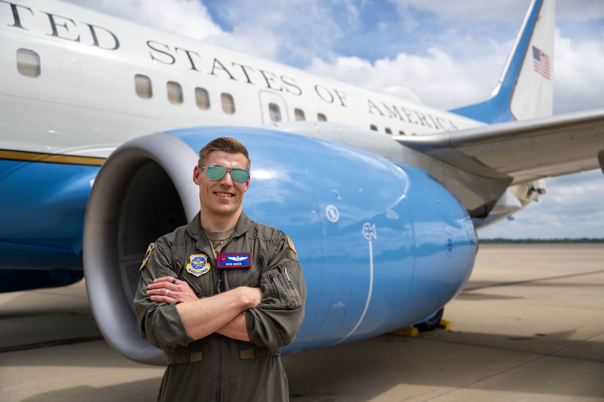 Pilot stands in front of plane.