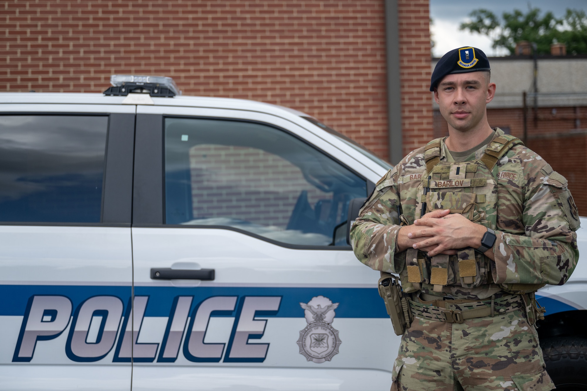 Persson stands in front of police truck.