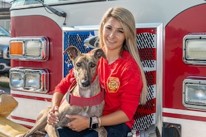 Image of person posing for photo with service dog.