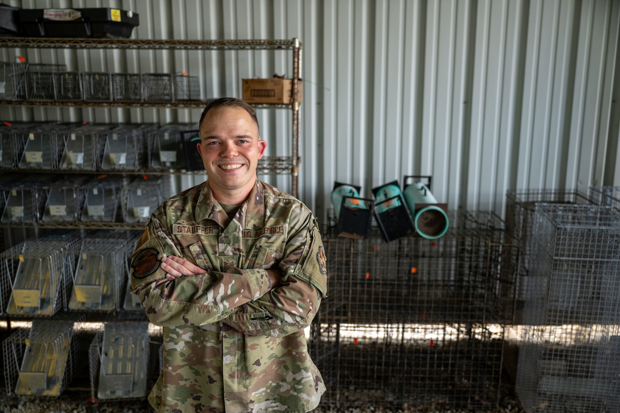 Person stands in front of cages.