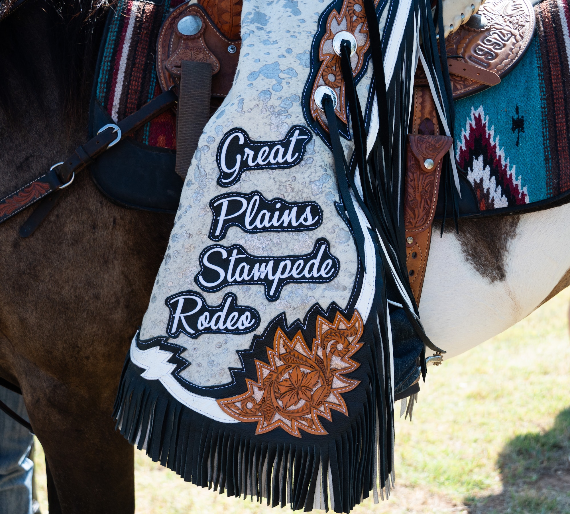 A member of the Great Plains Stampede Rodeo court pauses for photos during the 27th Annual Cattle Drive at Altus Air Force Base, Oklahoma, Aug. 21, 2025. This cattle drive kicks off the 42nd Great Plains Stampede Rodeo, which ends on Saturday with a parade through the streets of Altus. (U.S. Air Force photo by Tech. Sgt. Hailey Haux)