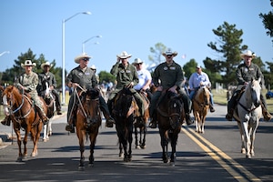 97th Air Mobility Wing leadership ride alongside each other in support of the 2025 Cattle Drive at Altus Air Force Base (AFB), Oklahoma, Aug. 21, 2025. This year marks the 27th Annual Cattle Drive, an event which is held in support of the bond between Altus AFB and the local community. (U.S. Air Force photo by Airman 1st Class Nathan Langston)
