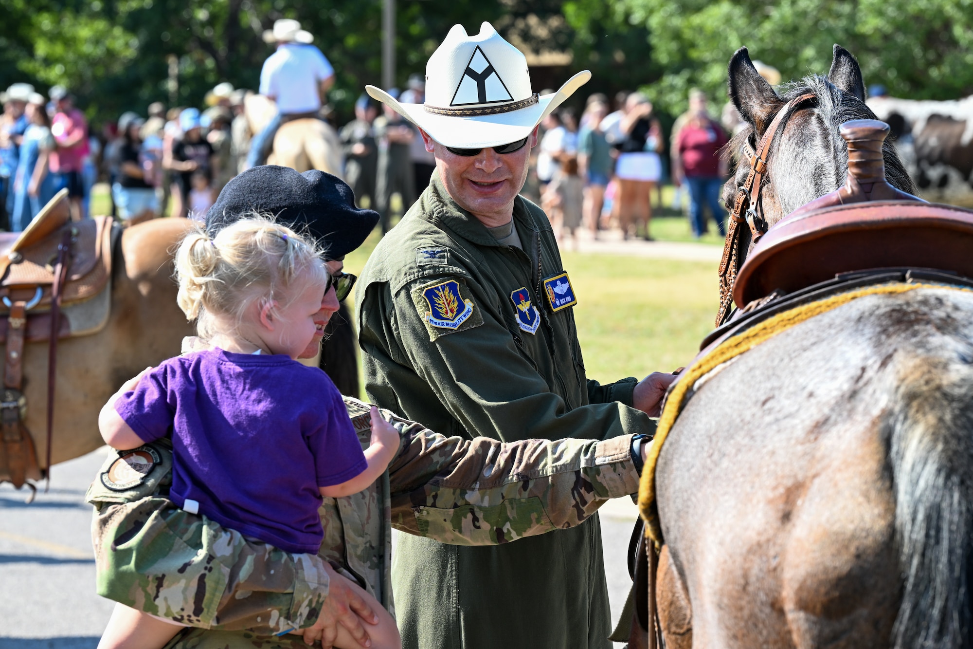 Col. Richard Kind, 97th Air Mobility Wing commander, displays his horse to spectators during the 2025 Cattle Drive at Altus Air Force Base (AFB), Oklahoma, Aug. 21, 2025. The Cattle Drive is an event that involves approximately 20-30 longhorn cattle parading through the streets of Altus AFB in recognition of the longstanding bond between Airmen and local ranchers. (U.S. Air Force photo by Airman 1st Class Nathan Langston)