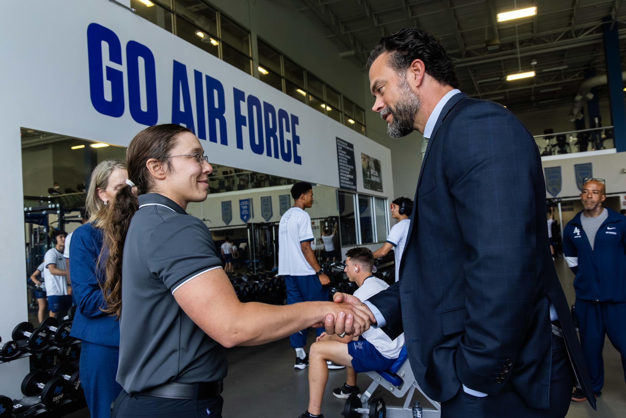 Undersecretary of the Air Force Matthew Lohmeier, right, speaks with Taylor Lorbiecki, left, a strength and conditioning coach, at the U.S. Air Force Academy, Colorado on August 19, 2025.