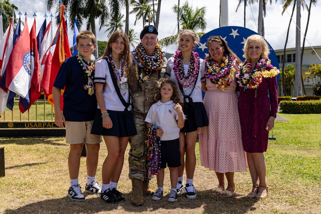 U.S. Army Brig. Gen. Thomas E. Burke, USARPAC Chief of Staff, stands with his family after a "Flying V" ceremony at Fort Shafter, Hawaii, on Aug. 22, 2025. The ceremony was held to honor incoming members of the USARPAC team and welcome Burke, as well as the incoming G3. (U.S. Army photo by Sgt. Ian Burns)