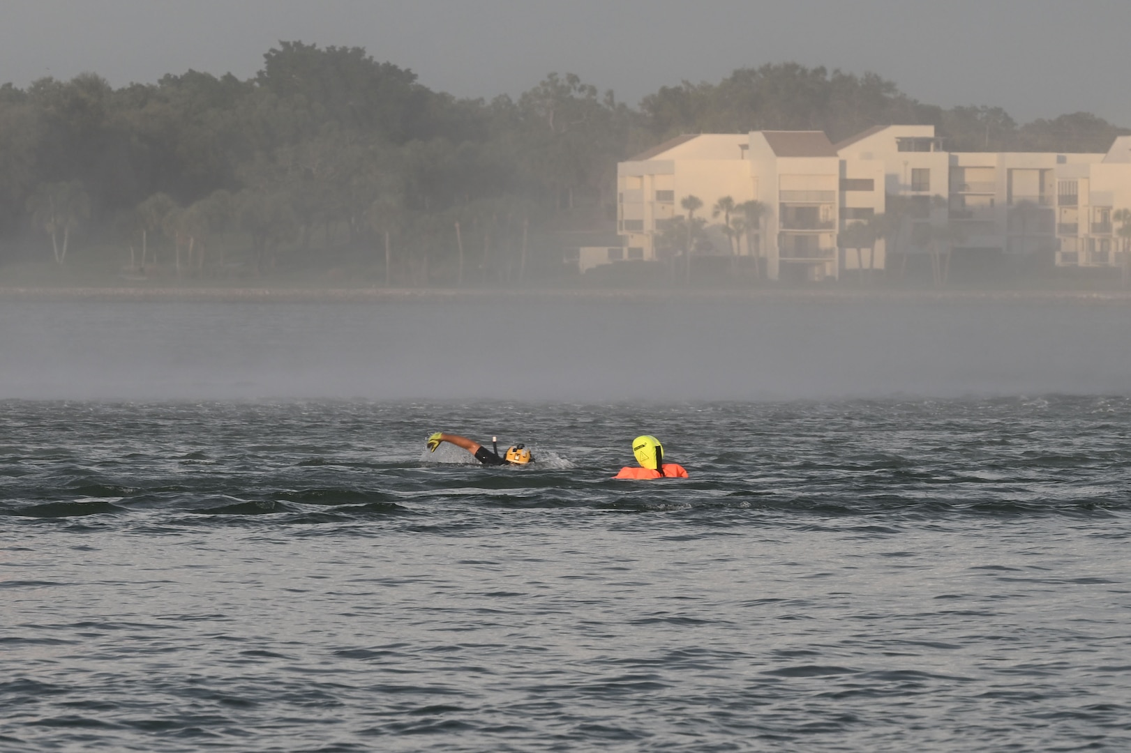 Petty Officer 2nd Class Zachary Loesch, a rescue swimmer assigned to U.S. Coast Guard Air Station Clearwater, swims toward a training dummy during search and rescue training in Sand Key, Florida, Aug. 13, 2025. U.S. Coast Guard Air Station Clearwaters rescue swimmer shop is the largest in the Coast Guard consisting of over 25 active duty aviation survival technicians. (U.S. Coast Guard photo by Petty Officer 1st Class Riley Perkofski)