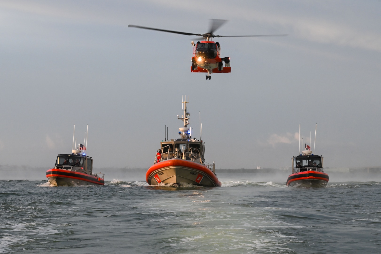 A U.S. Coast Guard Air Station Clearwater MH-60 Jayhawk aircrew flies behind U.S. Coast Guard Station Sand Key boat crews during training in Sand Key, Florida, Aug. 13, 2025. U.S. Coast Guard Sector St. Petersburg units carry out operational missions and are composed of over 825 Active Duty and Reserve Military Members, 27 Civilian, and 1800 Auxiliary personnel. (U.S. Coast Guard photo by Petty Officer 1st Class Riley Perkofski)