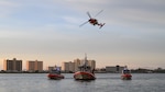 A U.S. Coast Guard Air Station Clearwater MH-60 Jayhawk aircrew breaks off behind U.S. Coast Guard Station Sand Key boat crews during training in Sand Key, Florida, Aug. 13, 2025. U.S. Coast Guard Sector St. Petersburg units carry out operational missions and are composed of over 825 Active Duty and Reserve Military Members, 27 Civilian, and 1800 Auxiliary personnel. (U.S. Coast Guard photo by Petty Officer 1st Class Riley Perkofski)