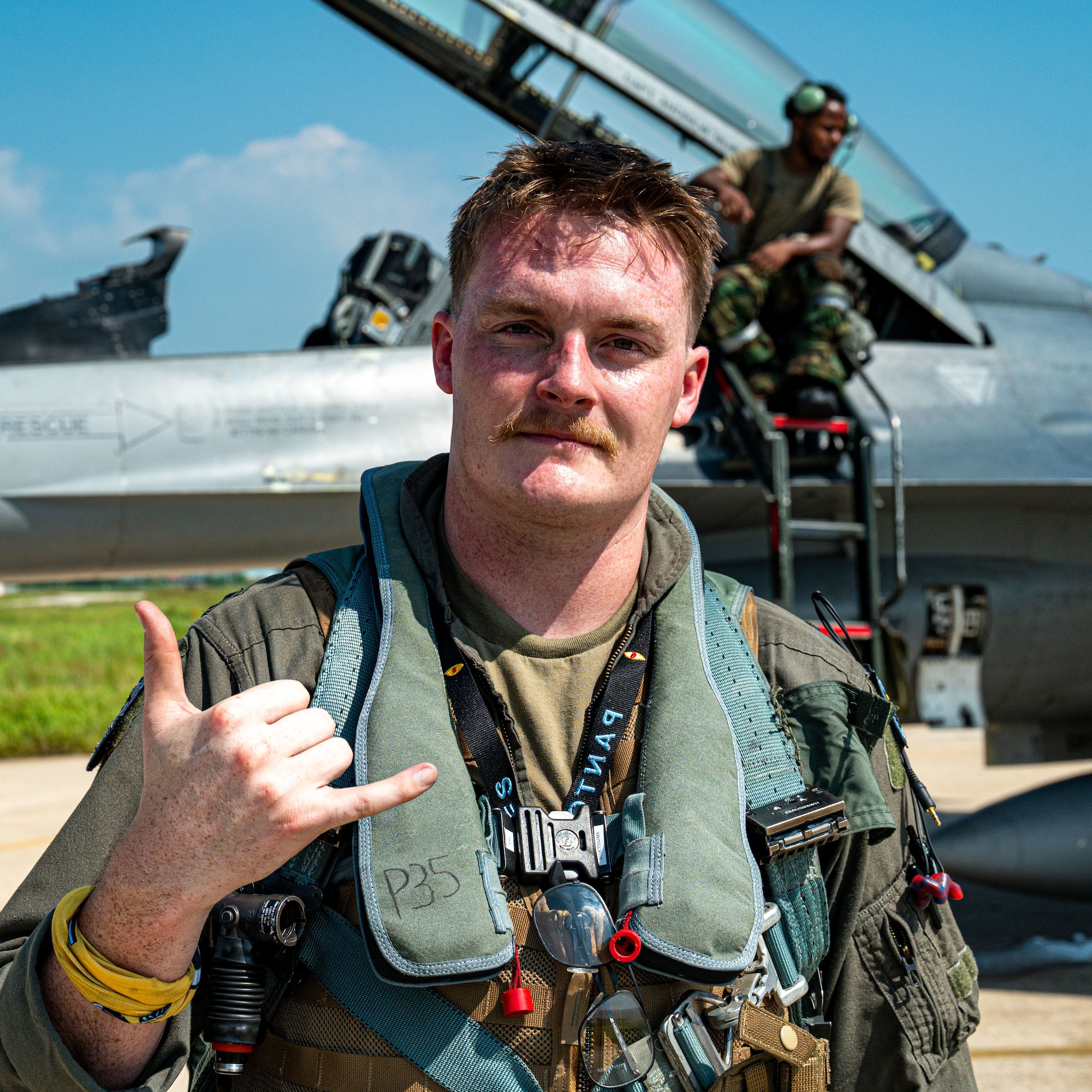 A fighter pilot poses for a photo