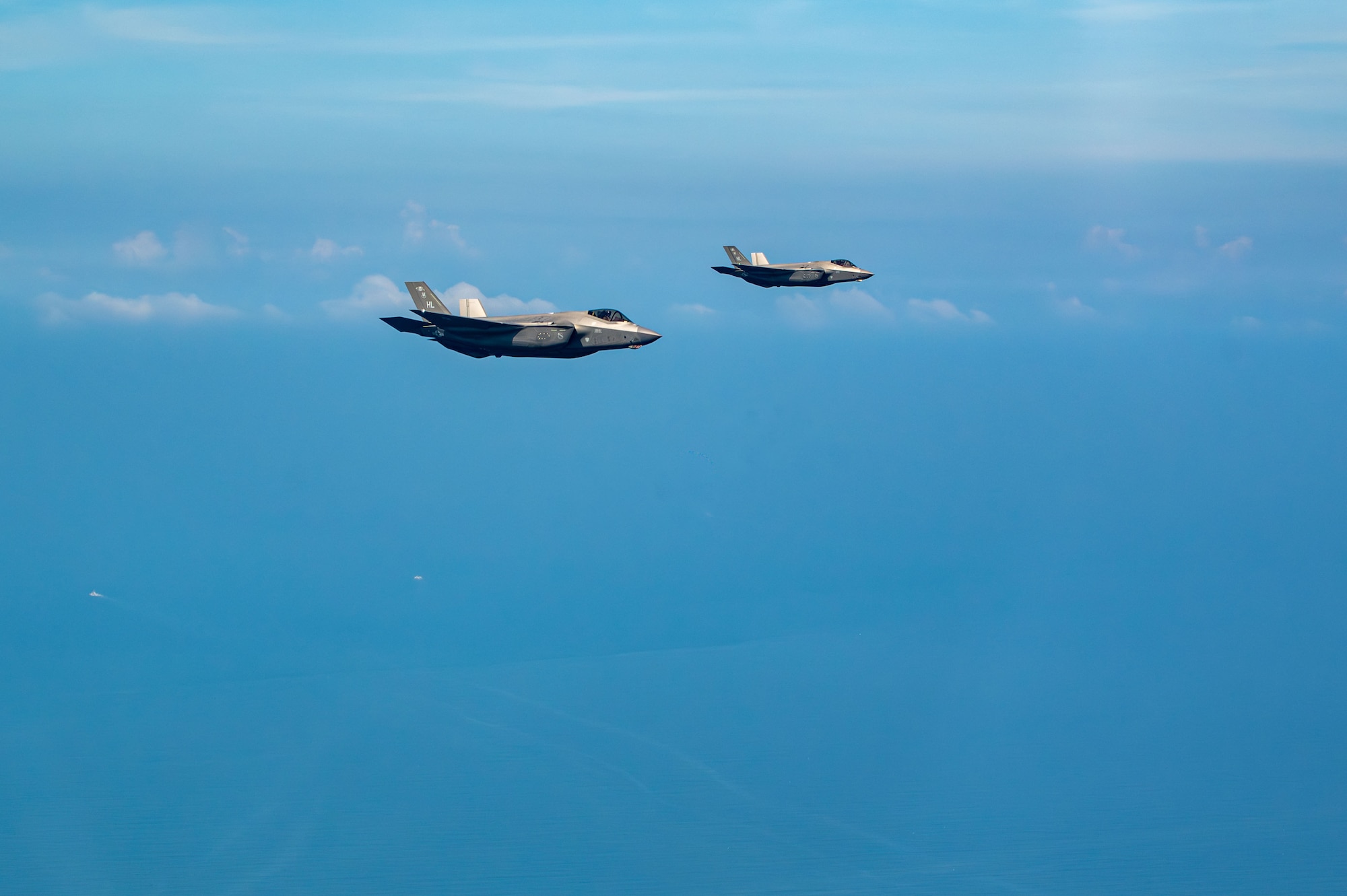 two jets flying next to another