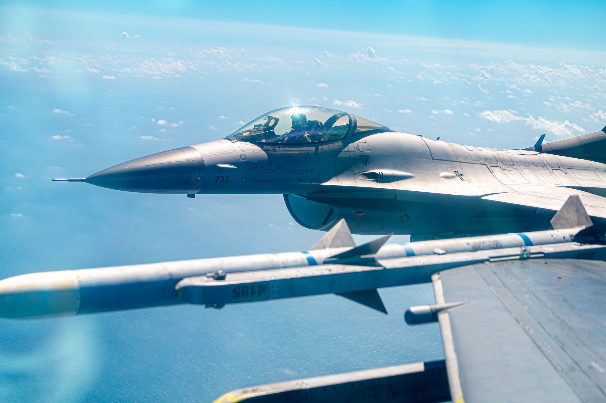 Two jets flying next to another