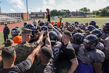 U.S. Marines with Marine Corps Recruiting Command huddle with the Randolph High School football team after a Marine Corps combat fitness test during Marine Week Boston, Aug. 21, 2025. During Marine Week Boston, Marines with Marine Corps Recruiting Command shared Marine Corps traditions with local high schools in honor of the Corps’ 250th birthday. Marines stationed across the globe commemorate the 250th anniversary of the Marine Corps, honoring a distinguished legacy of service, sacrifice, and unwavering fidelity to both the nation and fellow Marines. (U.S. Marine Corps photo by Sgt. Aidan Hekker)