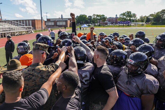U.S. Marines with Marine Corps Recruiting Command huddle with the Randolph High School football team after a Marine Corps combat fitness test during Marine Week Boston, Aug. 21, 2025. During Marine Week Boston, Marines with Marine Corps Recruiting Command shared Marine Corps traditions with local high schools in honor of the Corps’ 250th birthday. Marines stationed across the globe commemorate the 250th anniversary of the Marine Corps, honoring a distinguished legacy of service, sacrifice, and unwavering fidelity to both the nation and fellow Marines. (U.S. Marine Corps photo by Sgt. Aidan Hekker)