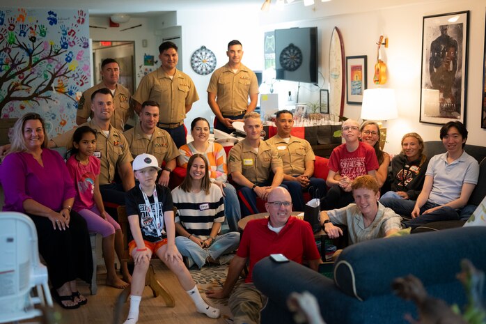 U.S. Marines with Special Purpose Marine-Air Ground Task Force-250, volunteers, and residents, pose for a photo at Christopher’s Haven, a temporary home for families and children receiving cancer treatment, during Marine Week Boston, Aug. 21, 2025. Marine Week Boston provides an opportunity for the Marine Corps to celebrate its 250th Birthday and connect with the community to show support while Christopher's Haven provides a supportive community of temporary apartments for families of children undergoing cancer treatment at nearby hospitals. (U.S. Marine Corps photo by Cpl. Vincent Needham)