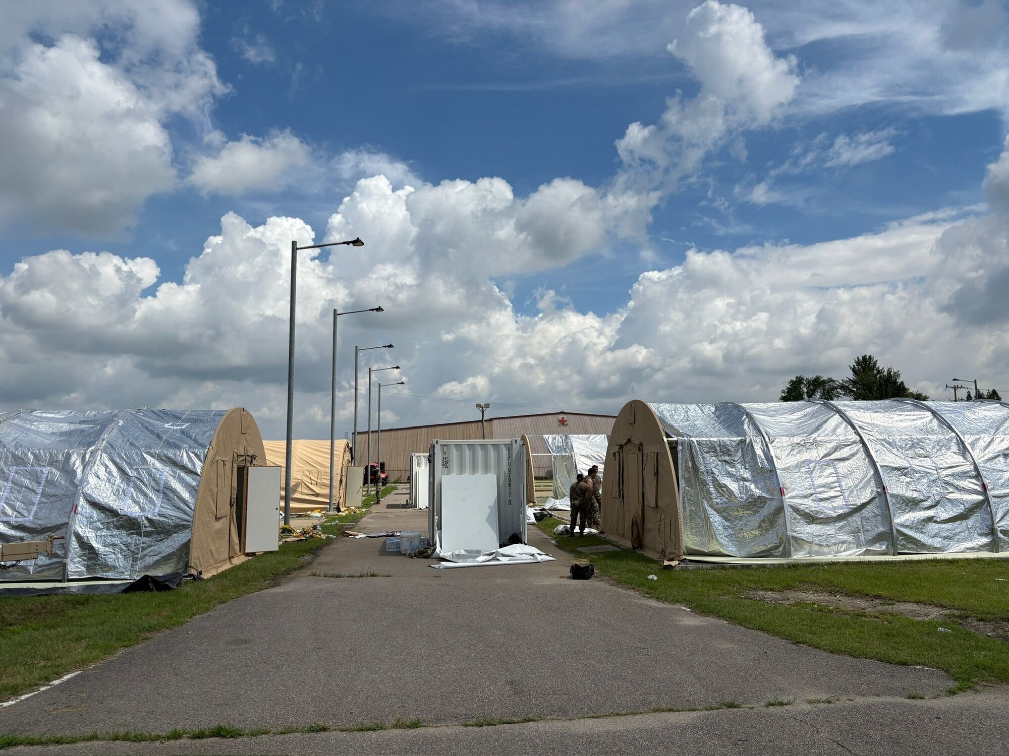 Rows of tent stand along a paved road.