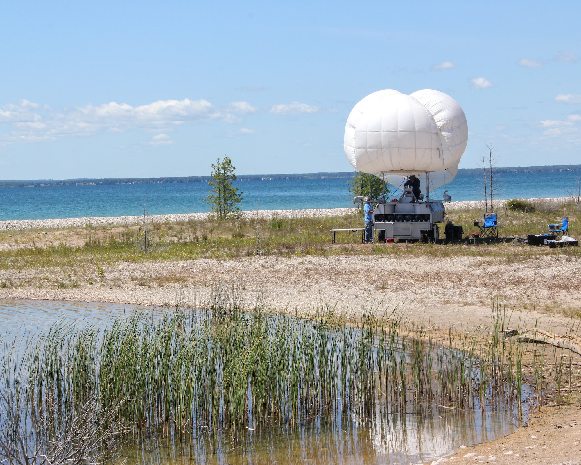 Technicians prepare a balloon for launch on the shore of Thunder Bay during Silent Swarm 25 in Alpena, Michigan, July 21, 2025.