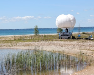 Technicians prepare a balloon for launch on the shore of Thunder Bay during Silent Swarm 25 in Alpena, Michigan, July 21, 2025.
