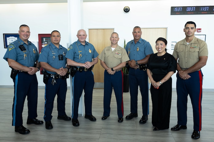 (From right to left) U.S. Marine Corps Capt. Kevin Uebelhardt, the deputy spokesman of Headquarters Marine Corps Communication Directorate with Special-Purpose Marine Air-Ground Task Force-250, Tracey Campbell, the director of U.S. Marine Corps Community Relations, and Col. J.J. Wilson, commanding officer of Special-Purpose Marine Air-Ground Task Force-250, pose for a photo at the Signature Aviation Boston Logan International Airport in Boston, Mass., Aug. 22, 2025. The Marine Corps is celebrating its 250th birthday by including activations across the city featuring aircraft, equipment, recruiting opportunities, and public engagements. (U.S. Marine Corps photo by Lance Cpl. Alondra Y. Lopez Gonzalez)