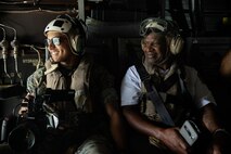 U.S. Marine Corps Lance Cpl. Juaquin Greaves, a combat videographer with Headquarters Marine Corps Communication Directorate, and a local firefighter, participate in an outreach and engagement Flight as part of Marine Week Boston 2025 in Boston, Mass., Aug. 22, 2025. The Marine Corps is celebrating its 250th birthday by including activations across the city featuring aircraft, equipment, recruiting opportunities, and public engagements. (U.S. Marine Corps photo by Lance Cpl. Alondra Y. Lopez Gonzalez)