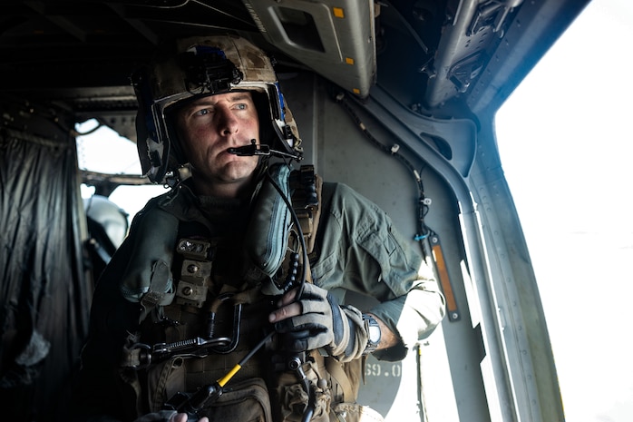 U.S. Marine Corps Staff Sgt. Curtis Anglin, a crew chief with Marine Medium Tiltrotor Squadron (VMM-774) assigned to Special Purpose Marine Air-Ground Task Force-250, looks out of an MV-22B Osprey at the Signature Aviation Boston Logan International Airport in Boston, Mass., Aug. 22, 2025. The Marine Corps is celebrating its 250th birthday by including activations across the city featuring aircraft, equipment, recruiting opportunities, and public engagements. (U.S. Marine Corps photo by Lance Cpl. Alondra Y. Lopez Gonzalez)