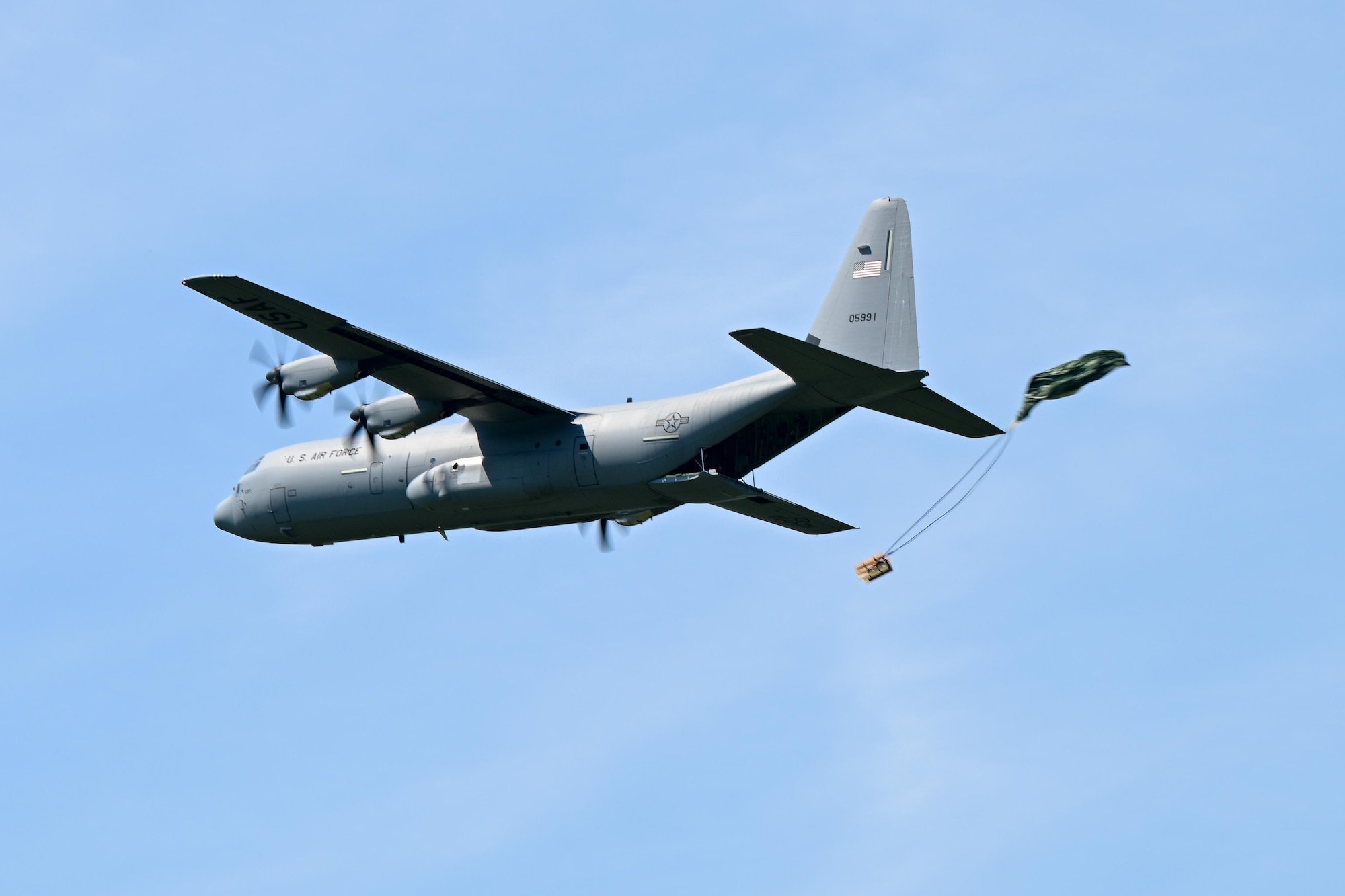 A C-130J Super Hercules from Youngstown Air Reserve Station drops a bundle over the Slagle Drop Zone at Camp James A. Garfield Joint Military Training Center, Ohio, during an exercise, July 24, 2025.