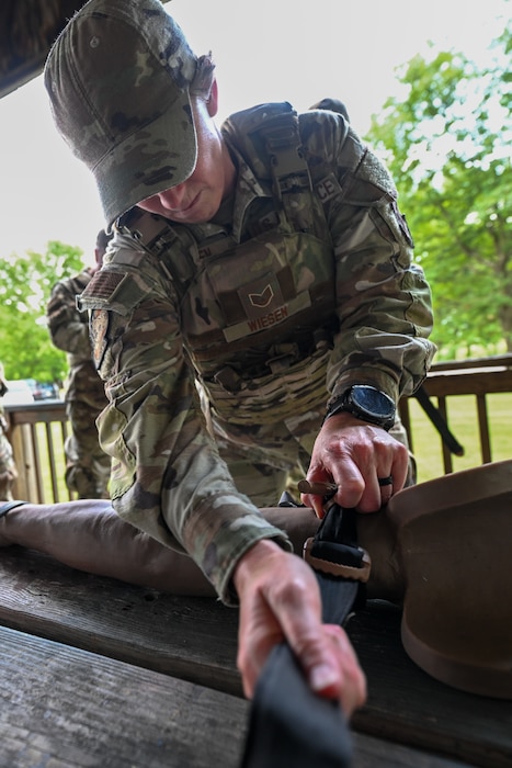 Staff Sgt. Danielle Wiesen, a member of the 910th Aircraft Maintenance Squadron and Integrated Defense Leadership Course student, applies a tourniquet during tactical combat casualty care training at Youngstown Air Reserve Station, Ohio, July 17, 2025.