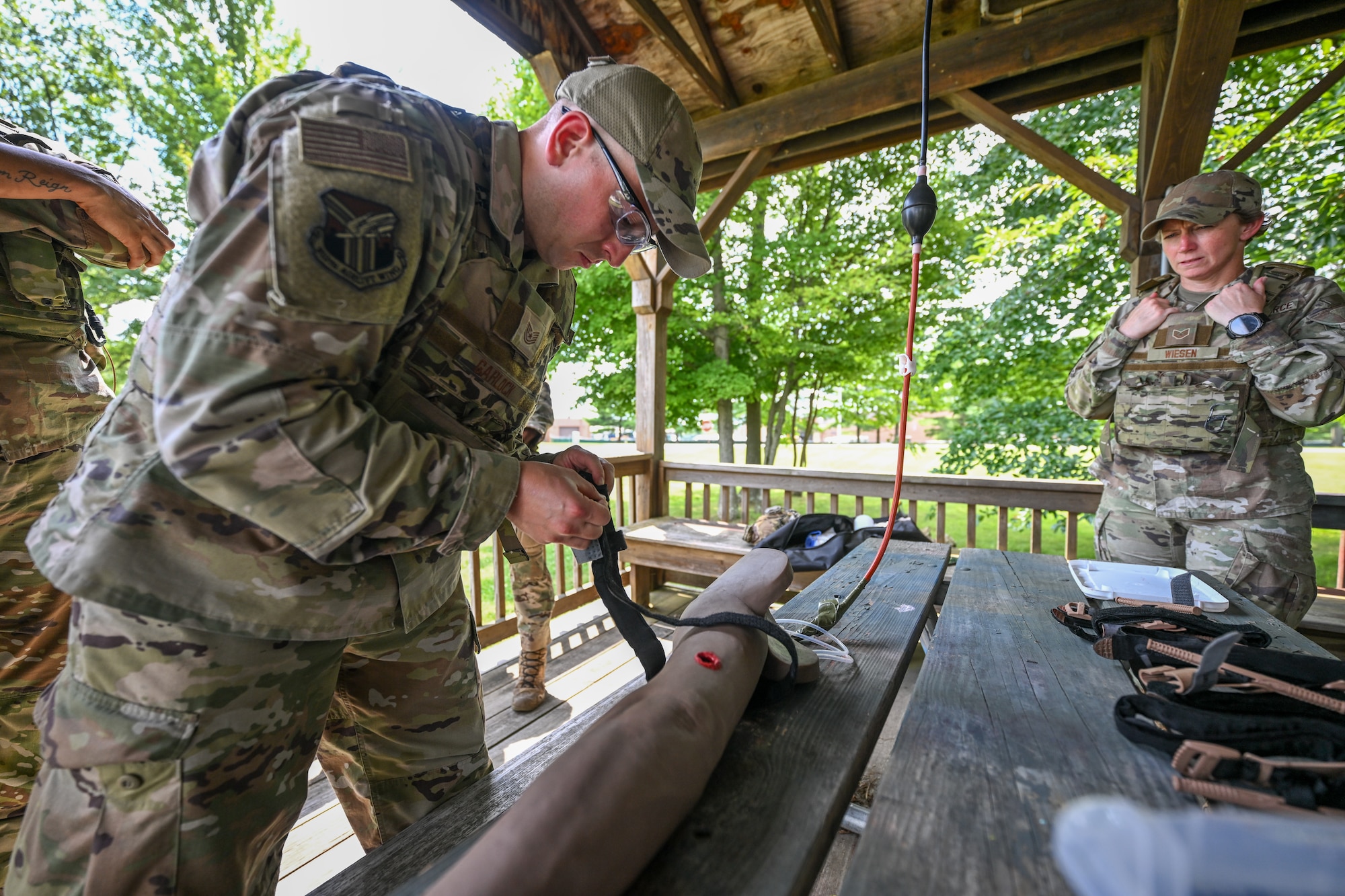 Tech. Sgt. Joshua Garlock, a member of the 910th Maintenance Squadron and Integrated Defense Leadership Course student, applies a tourniquet during tactical combat casualty care training at Youngstown Air Reserve Station, Ohio, July 17, 2025.