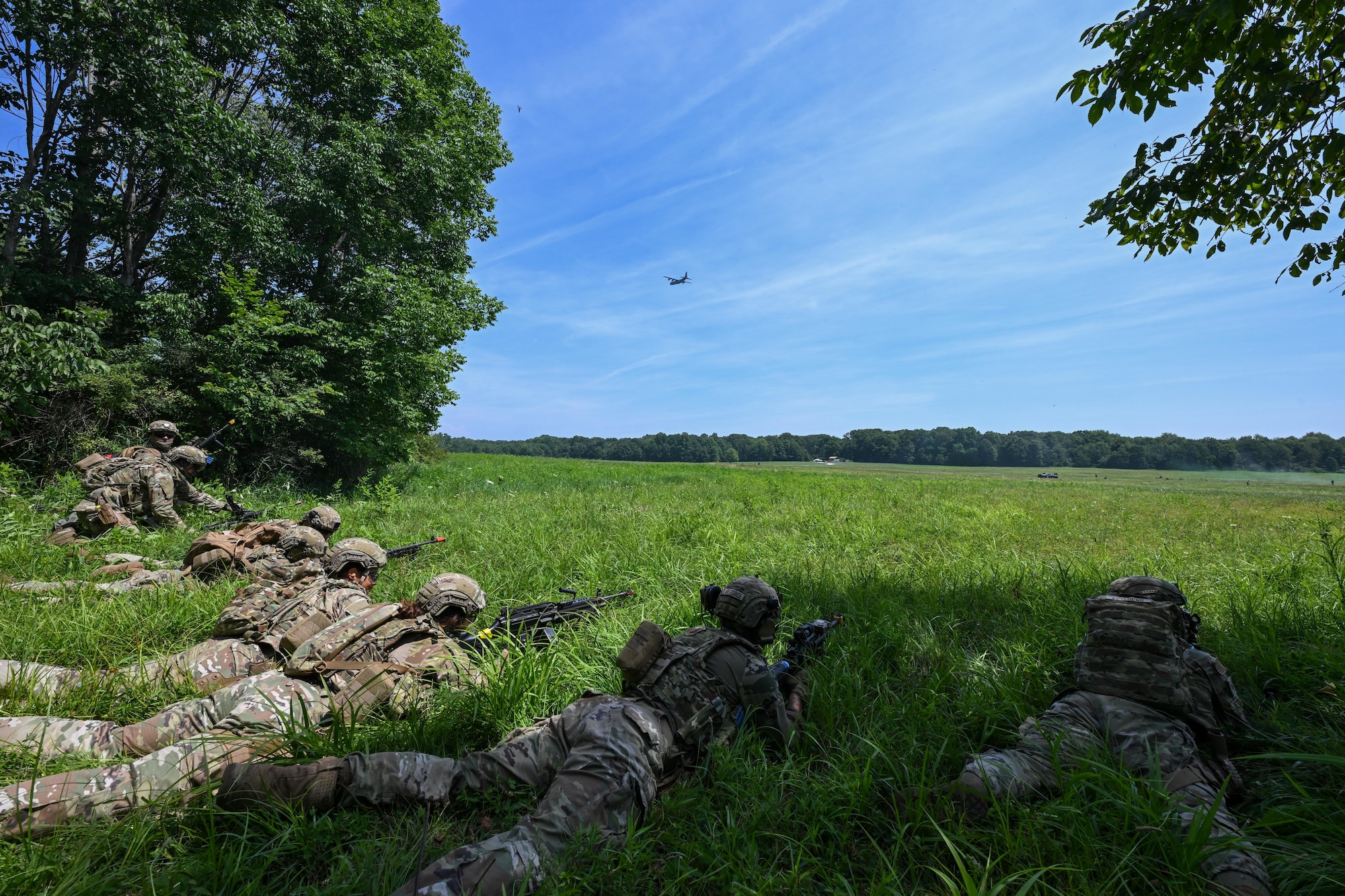 Integrated Defense Leadership Course students take a defensive position during an engagement with opposing forces at the Slagle Drop Zone at Camp James A. Garfield Joint Military Training Center, Ohio, during an exercise, July 24, 2025.