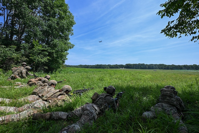 Integrated Defense Leadership Course students take a defensive position during an engagement with opposing forces at the Slagle Drop Zone at Camp James A. Garfield Joint Military Training Center, Ohio, during an exercise, July 24, 2025.